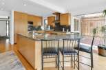 This stunning kitchen boasts a modern design with sleek cabinetry and a spacious island, perfect for both cooking and entertaining.