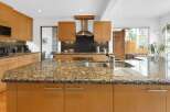 This stunning kitchen boasts a spacious granite countertop island, perfect for meal prep and entertaining.
