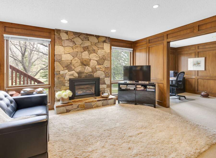 This stunning property boasts a cozy living room with a stone fireplace, perfect for relaxing evenings.