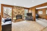 This stunning property boasts a cozy living room with a stone fireplace, perfect for relaxing evenings.