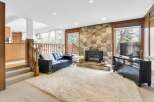 Step into luxury with this stunning living room featuring a cozy fireplace and a plush, oversized rug.