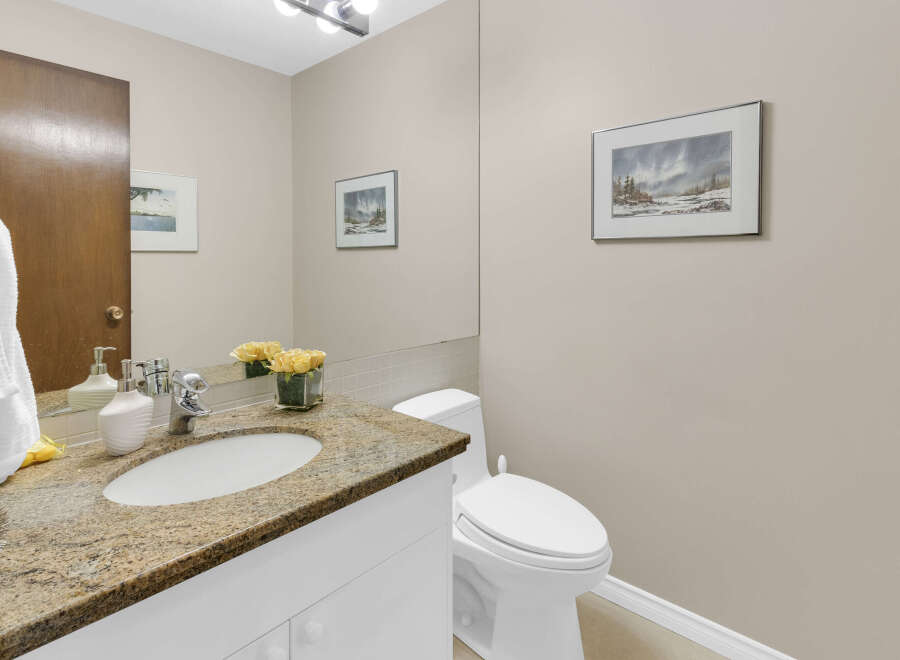 This elegant bathroom features a granite countertop, a stylish sink, and a modern faucet.