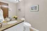This elegant bathroom features a granite countertop, a stylish sink, and a modern faucet.