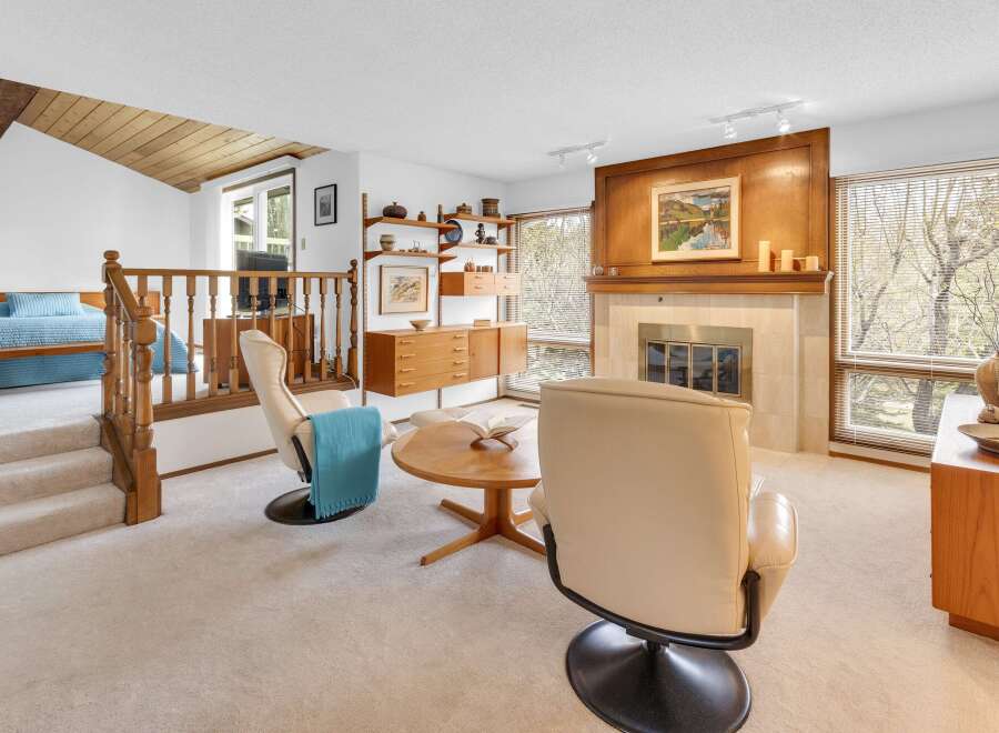 Step into this inviting living space, featuring a cozy fireplace and ample natural light.