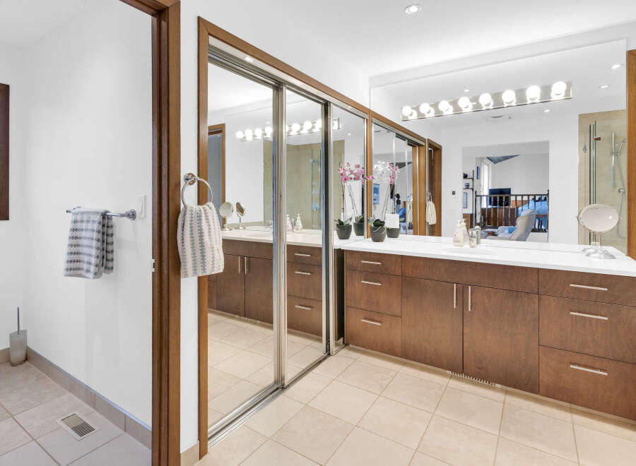 Step into luxury with this stunning bathroom featuring a sleek vanity and ample storage.