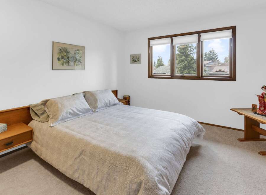 This inviting bedroom features a comfortable bed with soft bedding, perfect for a relaxing retreat.