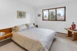 This inviting bedroom features a comfortable bed with soft bedding, perfect for a relaxing retreat.