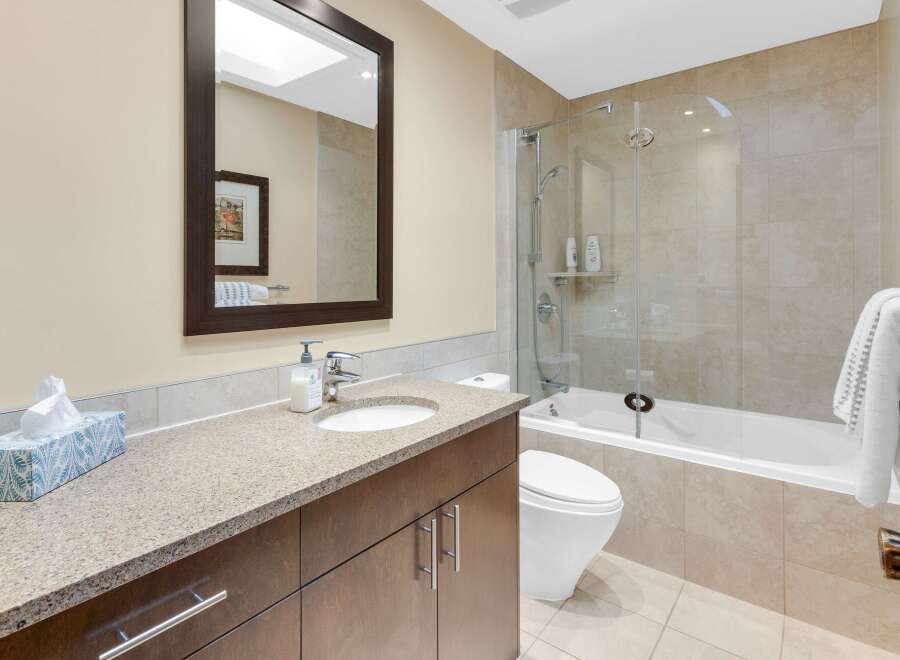 This stunning bathroom features a modern design with a sleek vanity and a spacious shower.