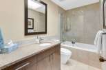 This stunning bathroom features a modern design with a sleek vanity and a spacious shower.