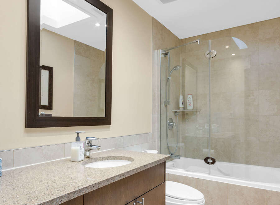 This modern bathroom features a sleek vanity with ample storage and a stylish countertop.