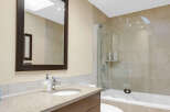 This modern bathroom features a sleek vanity with ample storage and a stylish countertop.