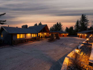This stunning property boasts a luxurious estate with a grand entrance and ample parking space.