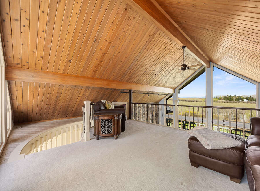 This stunning property boasts a spacious loft area with a vaulted wooden ceiling, creating an open and airy feel.