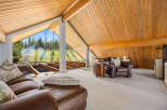 This stunning property boasts a unique architectural design with a vaulted, wood-paneled ceiling that adds warmth and character.