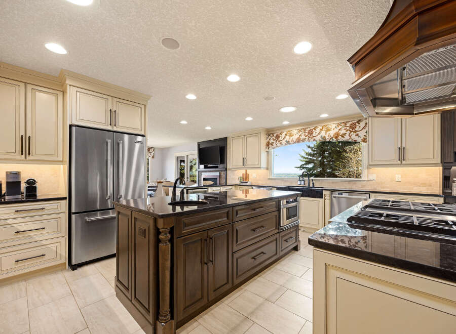 This stunning kitchen boasts a spacious layout with a large island, perfect for meal prep and entertaining.