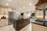 This stunning kitchen boasts a spacious layout with a large island, perfect for meal prep and entertaining.