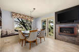 This stunning dining room features a cozy window seat, perfect for enjoying the natural light and scenic views.