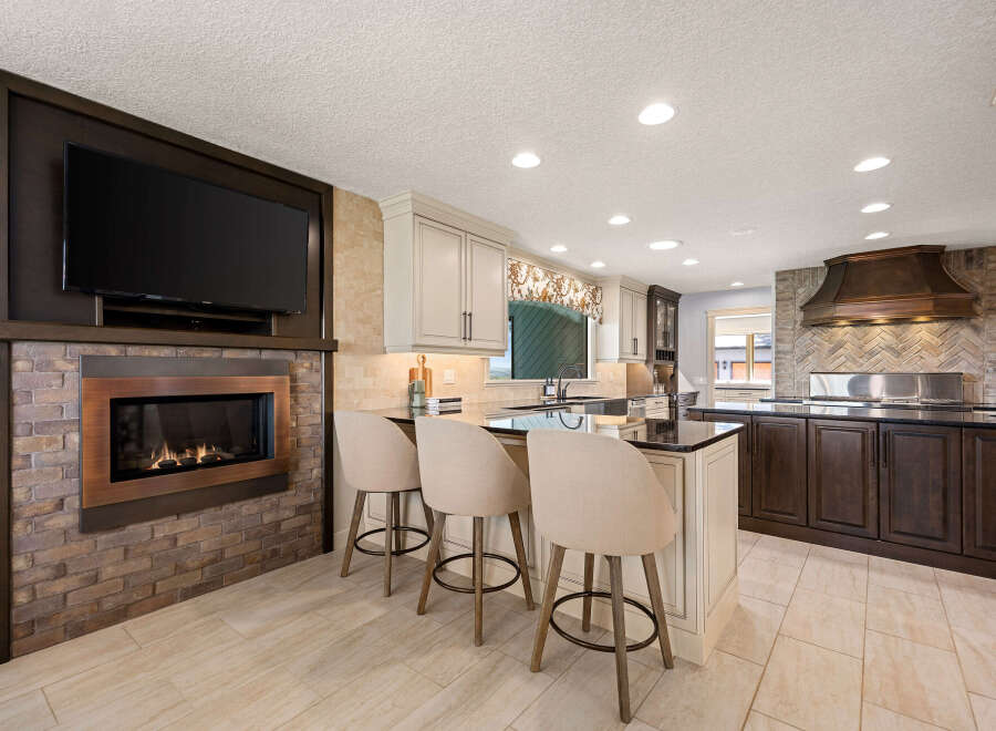 This stunning kitchen boasts a modern design with a cozy fireplace, perfect for creating a warm and inviting atmosphere.