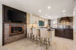 This stunning kitchen boasts a modern design with a cozy fireplace, perfect for creating a warm and inviting atmosphere.