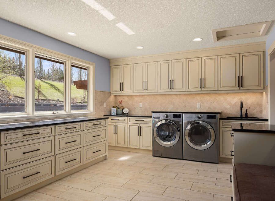 This stunning laundry room boasts a sleek design with ample storage and modern appliances.