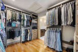Step into luxury with this stunning walk-in closet, designed for both style and functionality.