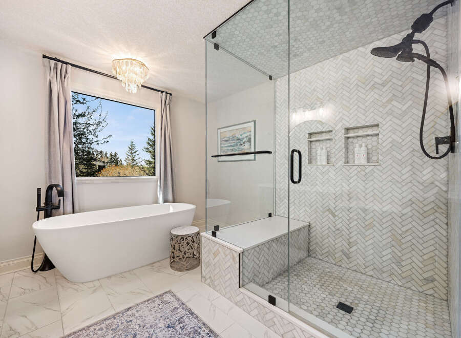 Step into luxury with this stunning bathroom featuring a modern freestanding tub, perfect for unwinding after a long day.