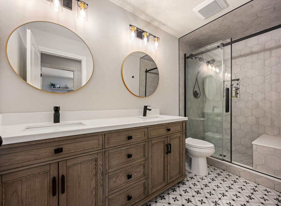 Step into luxury with this beautifully designed bathroom! Featuring a sleek vanity with double sinks, elegant mirrors, and stylish lighting, this space is perfect for your daily routine.