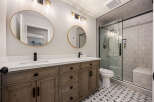 Step into luxury with this beautifully designed bathroom! Featuring a sleek vanity with double sinks, elegant mirrors, and stylish lighting, this space is perfect for your daily routine.