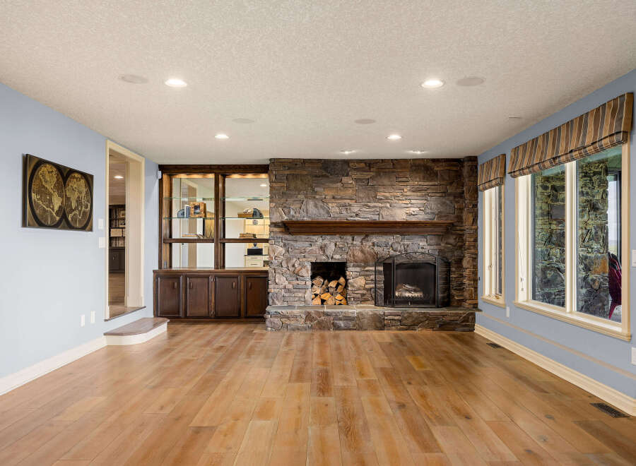 This stunning living room boasts a beautiful stone fireplace, perfect for cozy evenings.