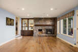 This stunning living room boasts a beautiful stone fireplace, perfect for cozy evenings.
