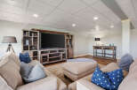 This stunning living room boasts a stylish entertainment center, perfect for movie nights and gatherings.