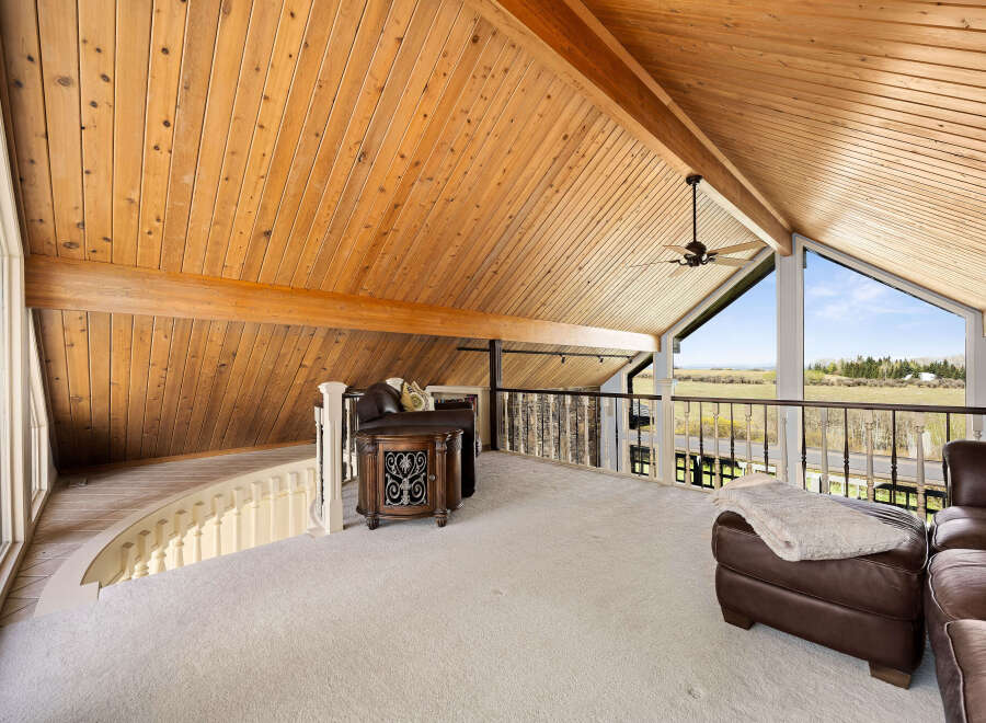 Experience the epitome of luxury in this stunning property, showcasing a vaulted wooden ceiling that adds warmth and character.