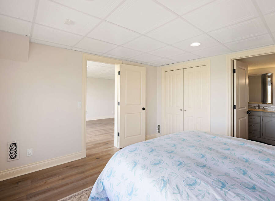 This inviting bedroom features a comfortable bed with a floral patterned duvet, perfect for a relaxing retreat.