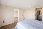 This inviting bedroom features a comfortable bed with a floral patterned duvet, perfect for a relaxing retreat.
