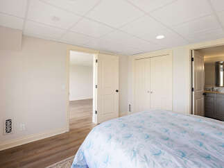 This inviting bedroom features a comfortable bed with a floral patterned duvet, perfect for a relaxing retreat.