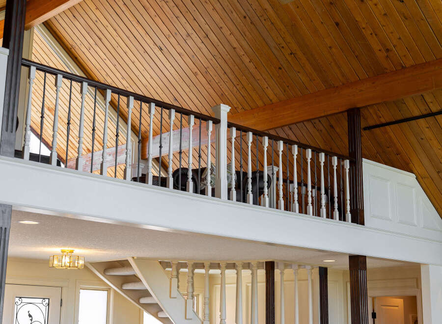 This stunning property boasts a grand, open-concept design with soaring ceilings and exquisite wooden accents throughout.