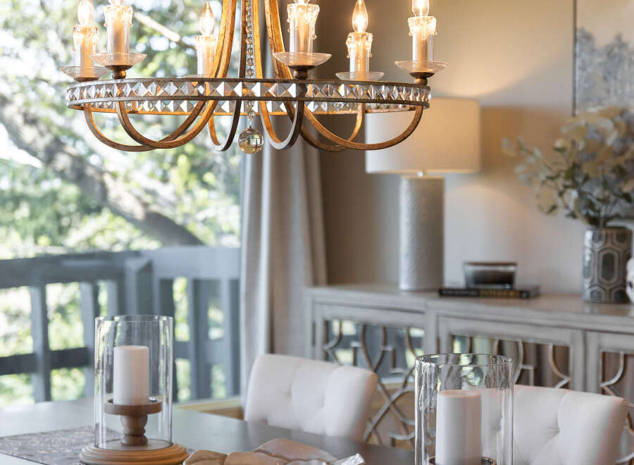 Step into elegance with this stunning dining room, featuring a beautiful chandelier that illuminates the space.