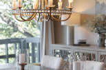 Step into elegance with this stunning dining room, featuring a beautiful chandelier that illuminates the space.
