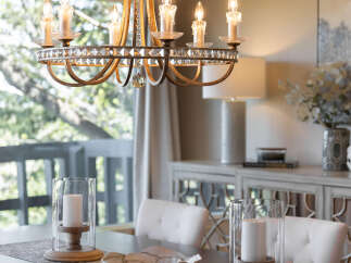 Step into elegance with this stunning dining room, featuring a beautiful chandelier that illuminates the space.