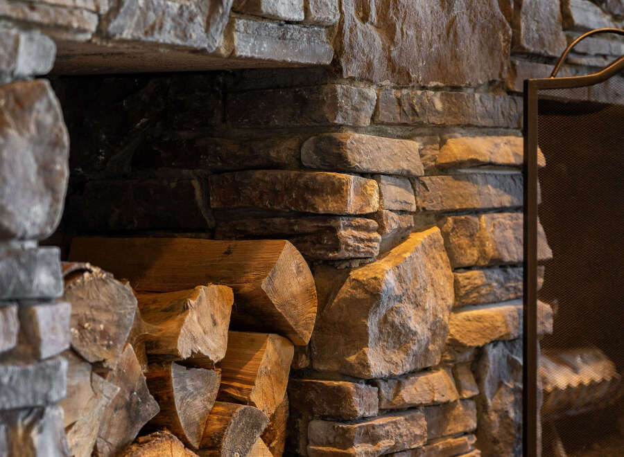 This stunning fireplace, crafted with natural stone, adds a touch of rustic elegance to any home.