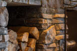 This stunning fireplace, crafted with natural stone, adds a touch of rustic elegance to any home.