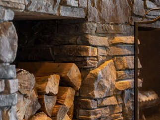 This stunning fireplace, crafted with natural stone, adds a touch of rustic elegance to any home.