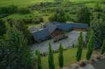 This stunning property boasts a luxurious home nestled in a serene, green landscape.