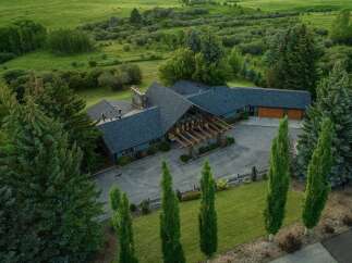 This stunning property boasts a luxurious home nestled in a serene, green landscape.