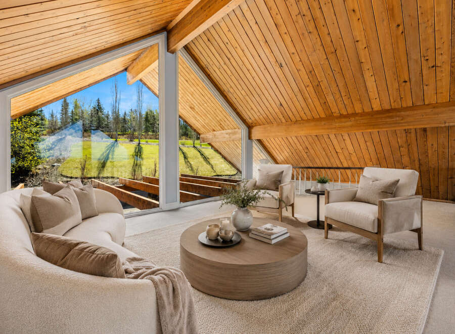Experience breathtaking natural light and stunning views through expansive windows in this beautifully appointed living space.