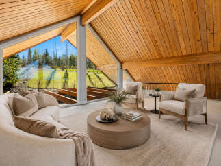 Experience breathtaking natural light and stunning views through expansive windows in this beautifully appointed living space.