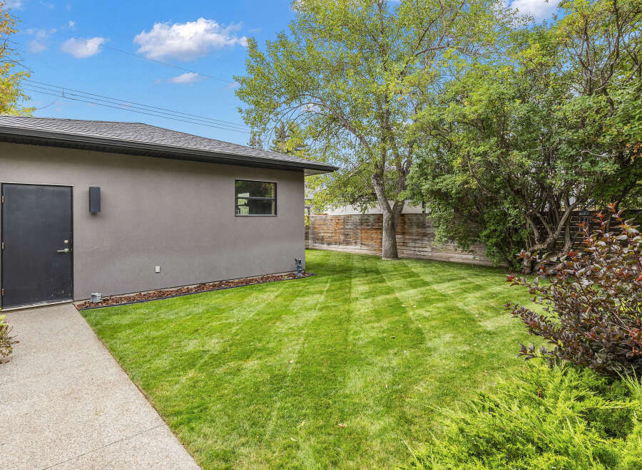 Discover the charm of this property, featuring a well-maintained backyard with lush green grass.