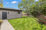 Discover the charm of this property, featuring a well-maintained backyard with lush green grass.