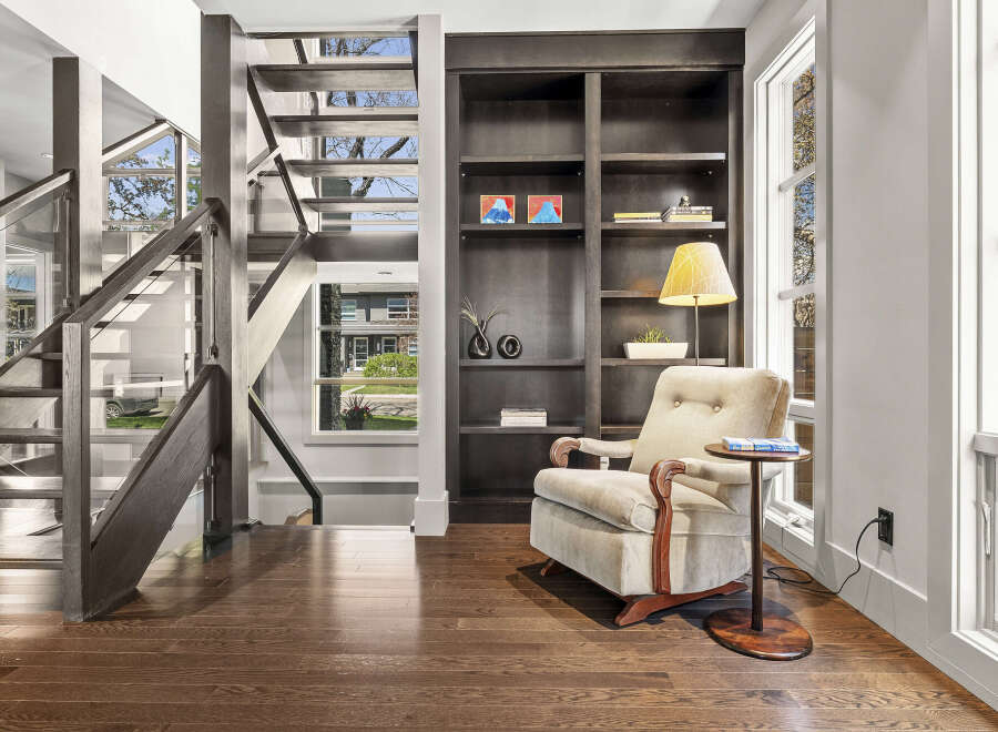 This stunning property boasts a modern interior with a beautiful staircase and hardwood floors.