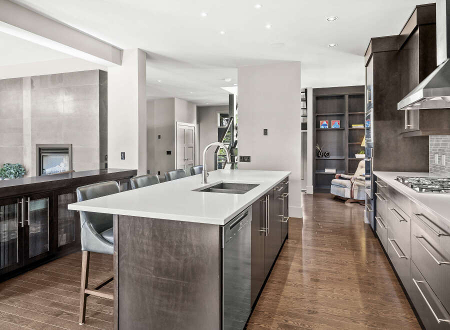 This stunning kitchen boasts a modern design with sleek cabinetry and a spacious island, perfect for both cooking and entertaining.